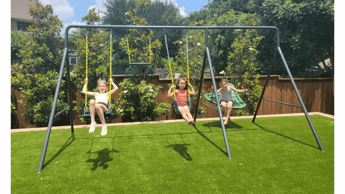 Three kids swinging on a swing set.