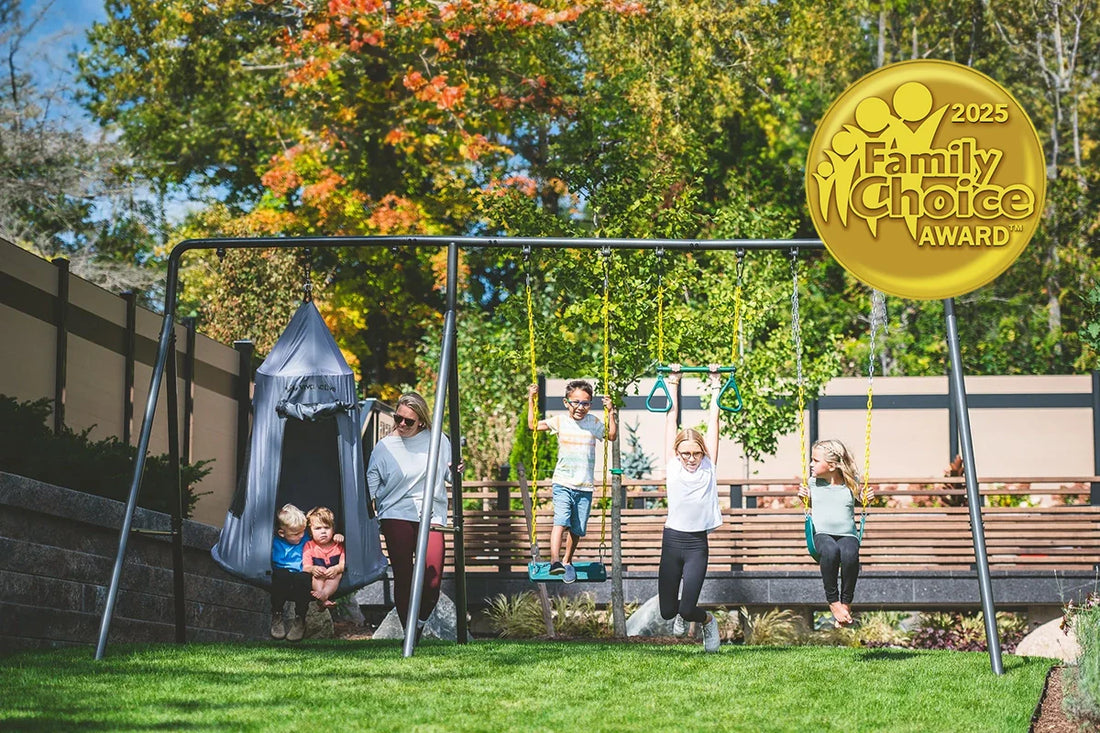 Five kids on a large metal swing with a woman supervising from behind. Family Choice Award badge is transposed on the image.